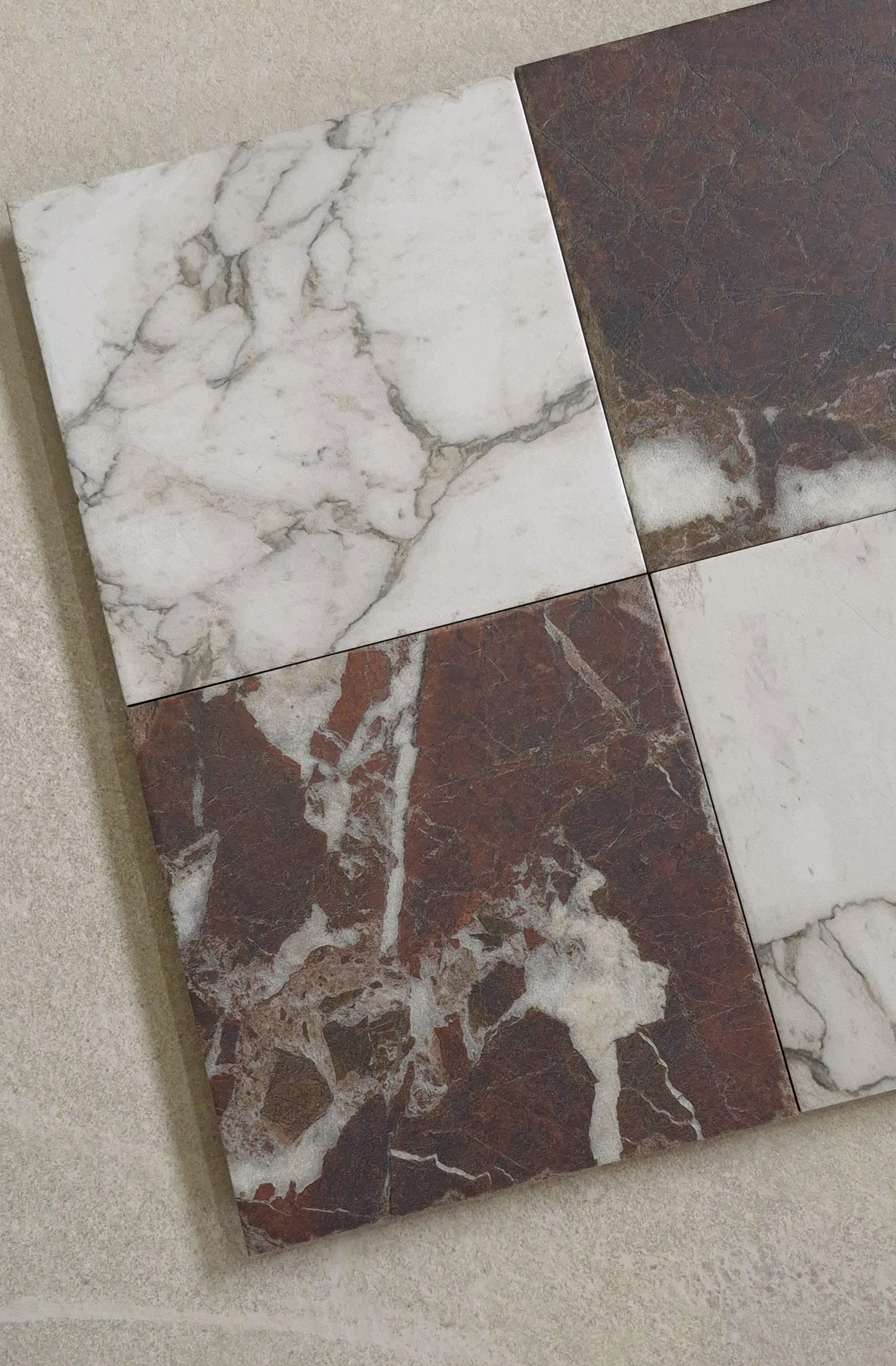 Marble look tile in a checkerboard floor installation