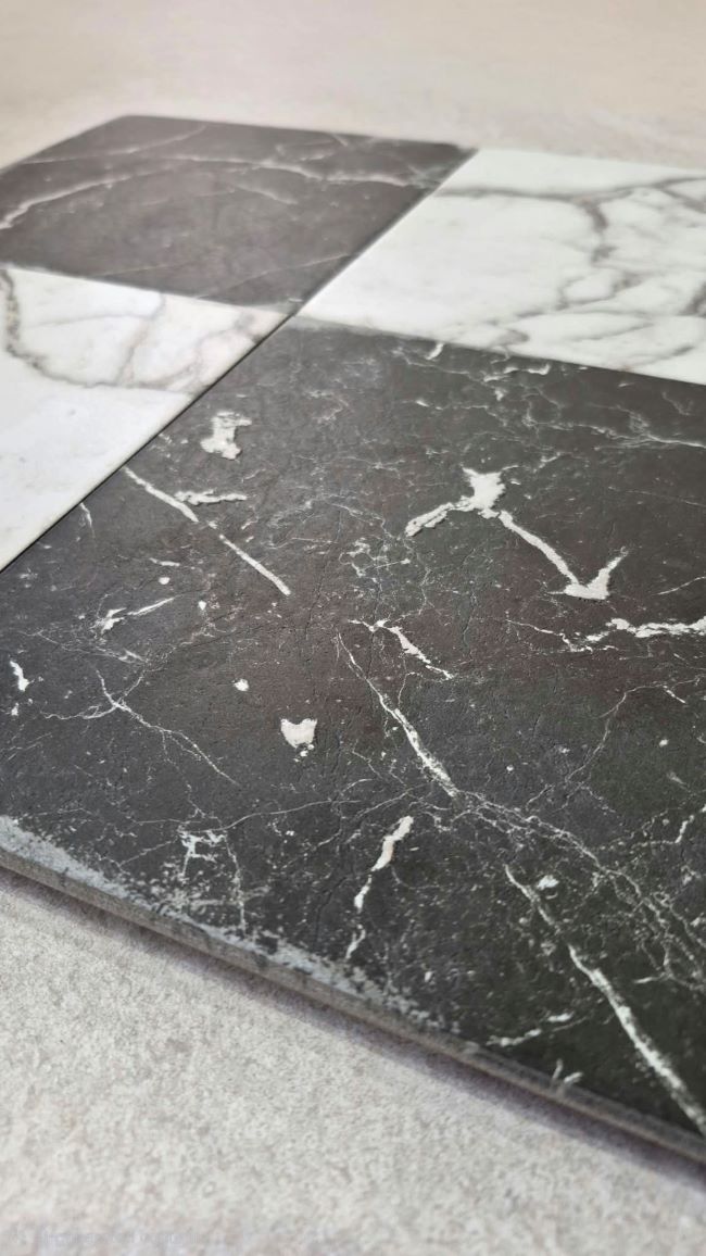 Tumbled black and white marble checkerboard porcelain floor tiles from Spain, close-up
