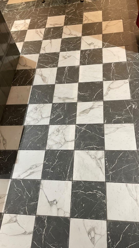 Black Nero Marquina and White Statuario marble look porcelain tiles laid in a checkerboard floor