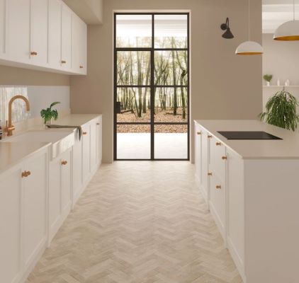 Pale cotto look herringbone floor tiles in a white galley kitchen