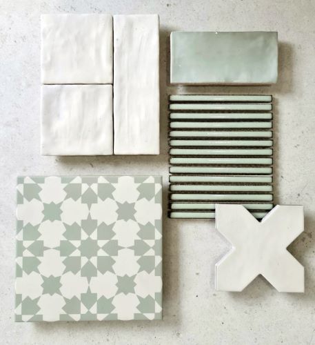Flat lay of KC955 sage green pattern tile with white handmade-look subway tiles, green fluted tile and a white cross-shaped tile