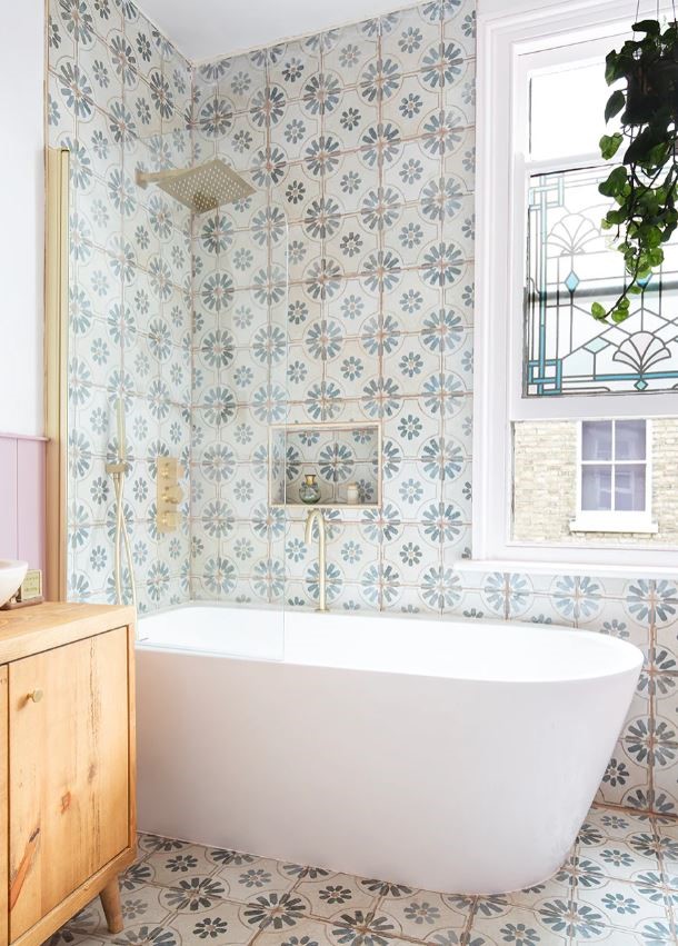 Farmhouse bathroom fully tiled in KC889 blue pattern tiles with a freestanding bath, shower niche and timber vanity
