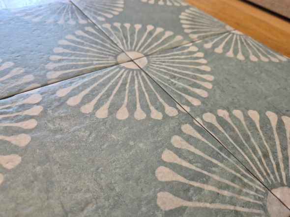 Sage green pattern floor tiles close up