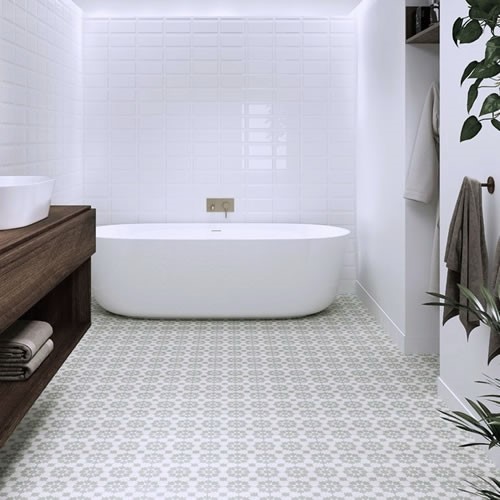 Bright bathroom with sage green pattern floor tiles, freestanding white bath, white subway walls and timber vanity