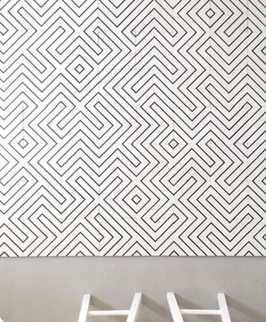 Black and white monochrome pattern tiles laid on a floor