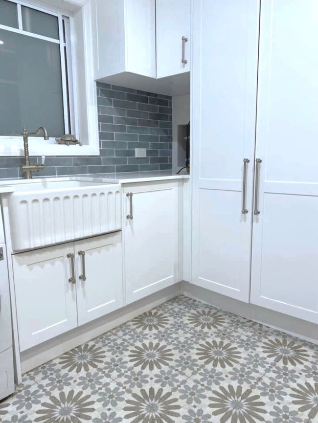 Kitchen with patterned floor tiles laid