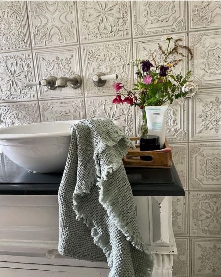 Spanish pressed metal look wall tiles in a vintage rustic bathroom